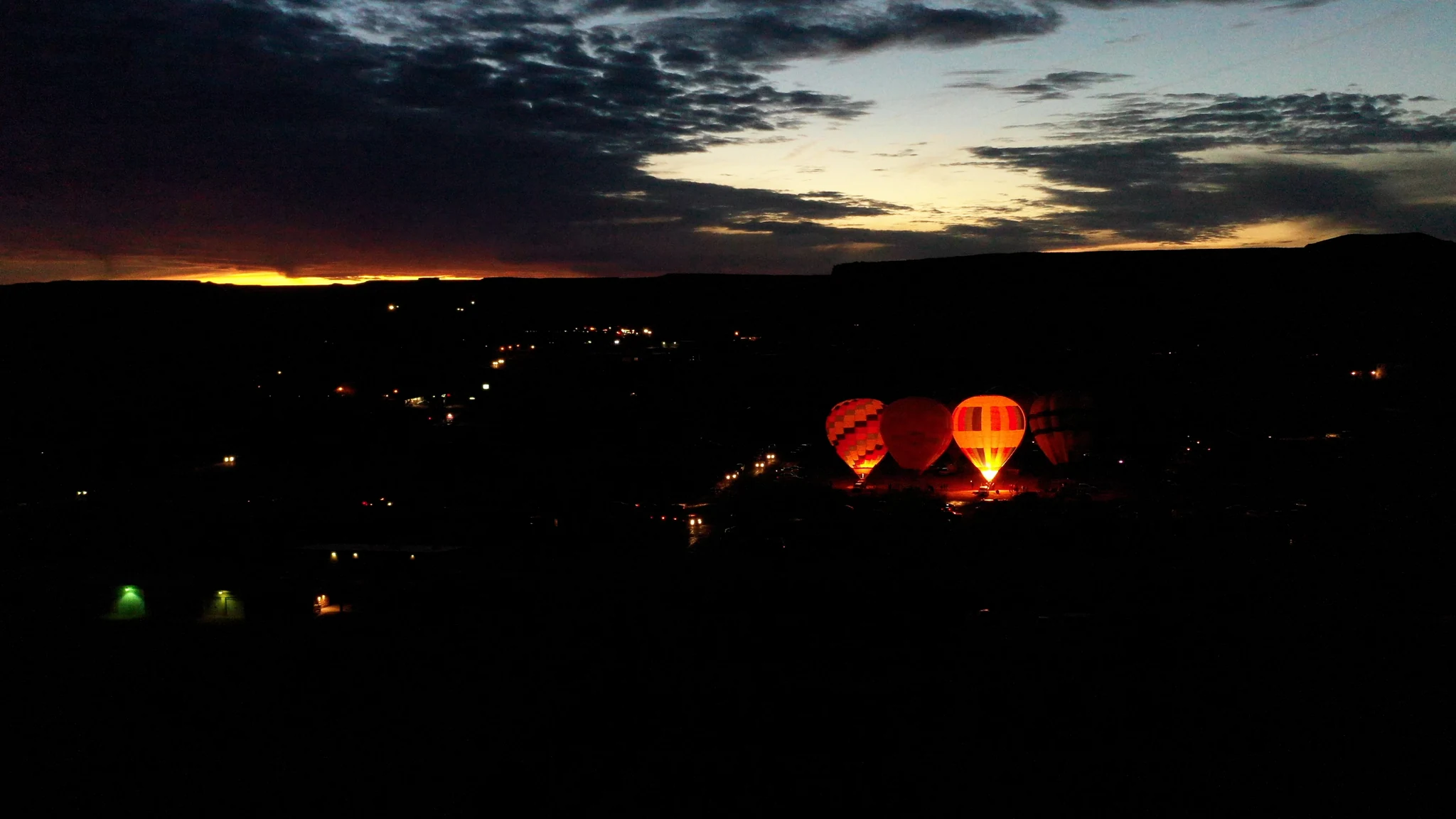 Balloons glowing below a darkening sky at dusk in Bluff.