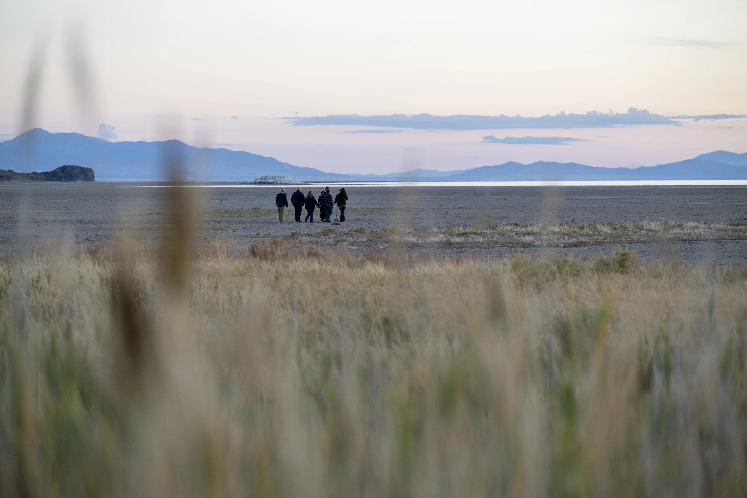 A group walking across the salt flats at Antelope Island, Utah