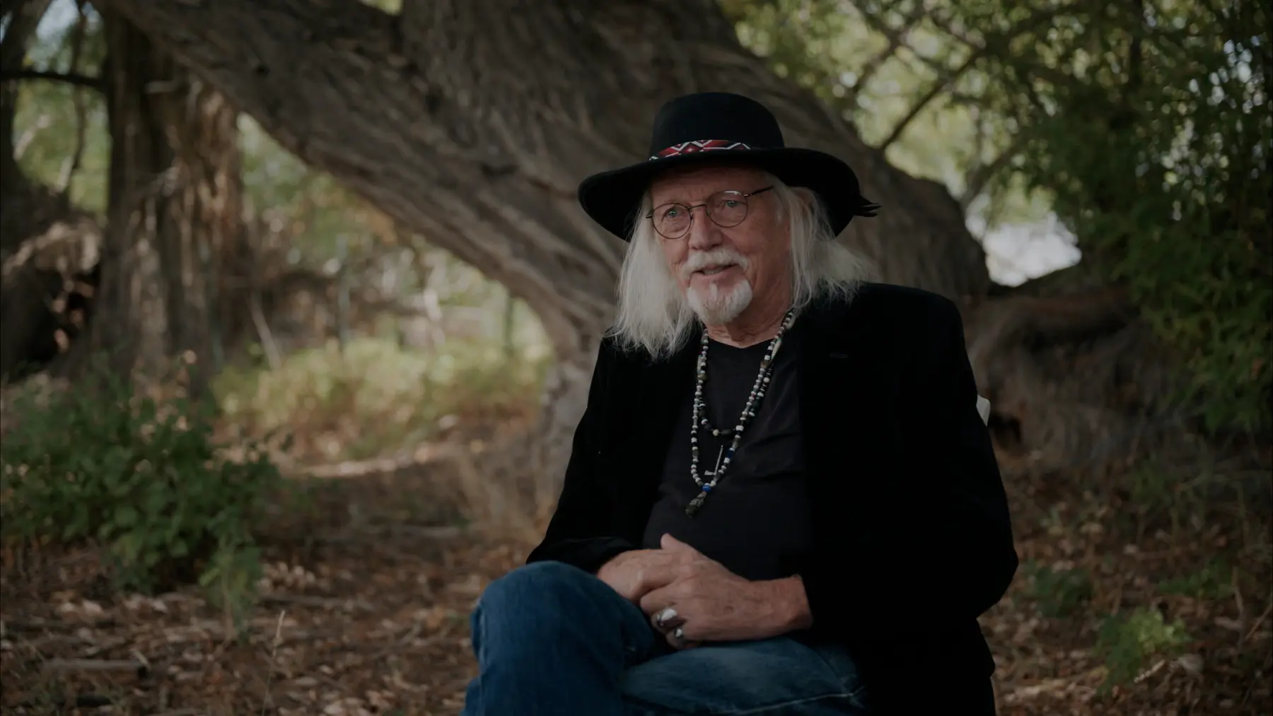 Phillip Gottfredson seated beneath a tree
