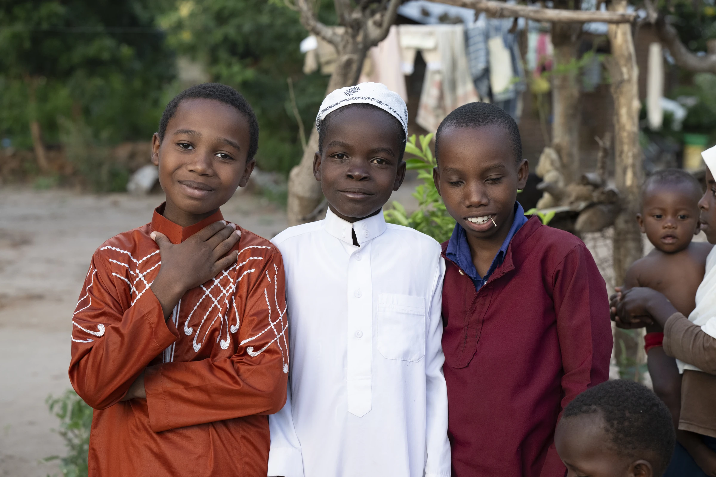 Three children posing together in Malawi