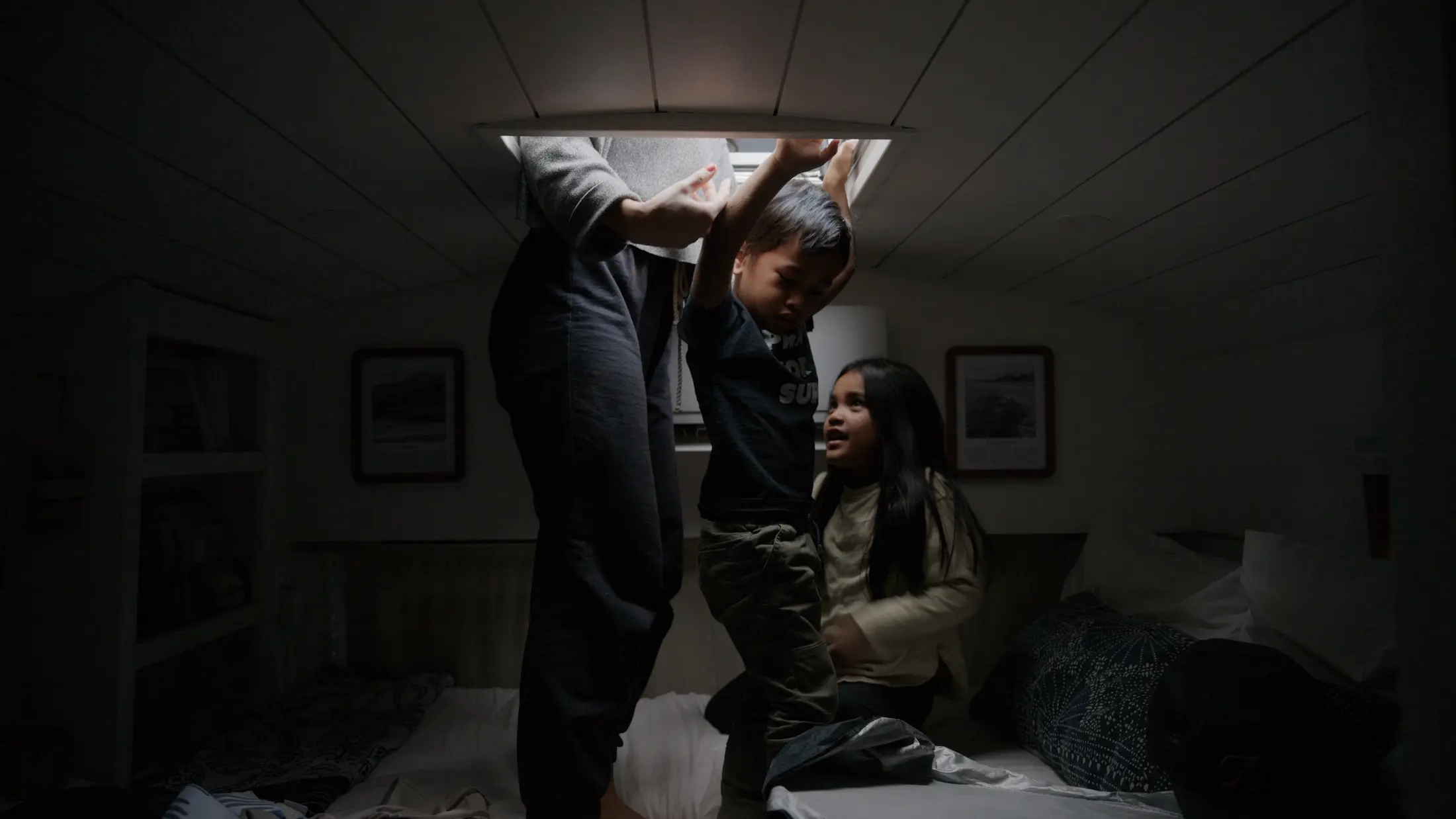 Children climbing through the bus roof hatch